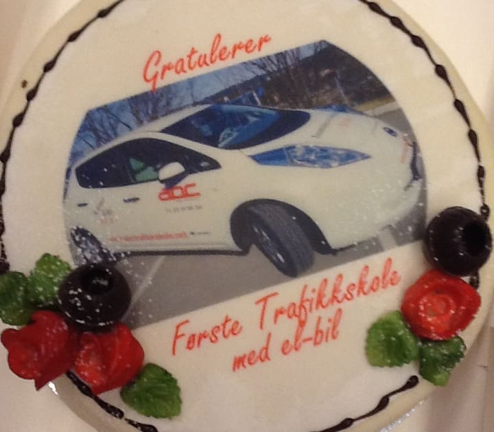 Bilde av kake med gratulasjoner for at ABC Trafikkskole var første trafikkskole i Oslo som tok i bruk EL-bil i undervisningen i 2012.